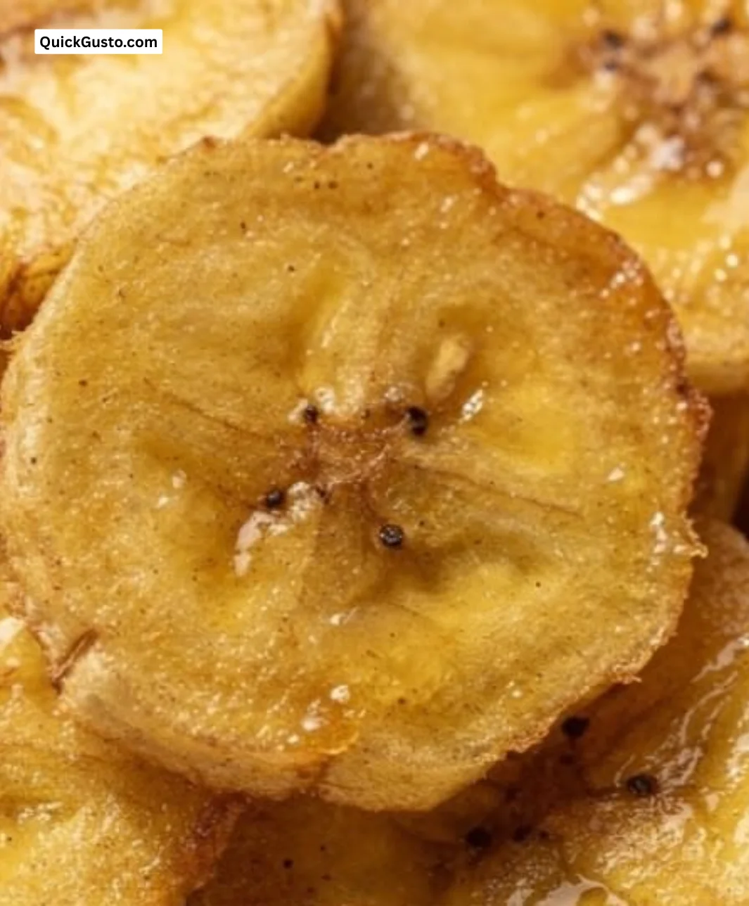 Bowl of crispy ginger banana chips with spices on a cozy kitchen table