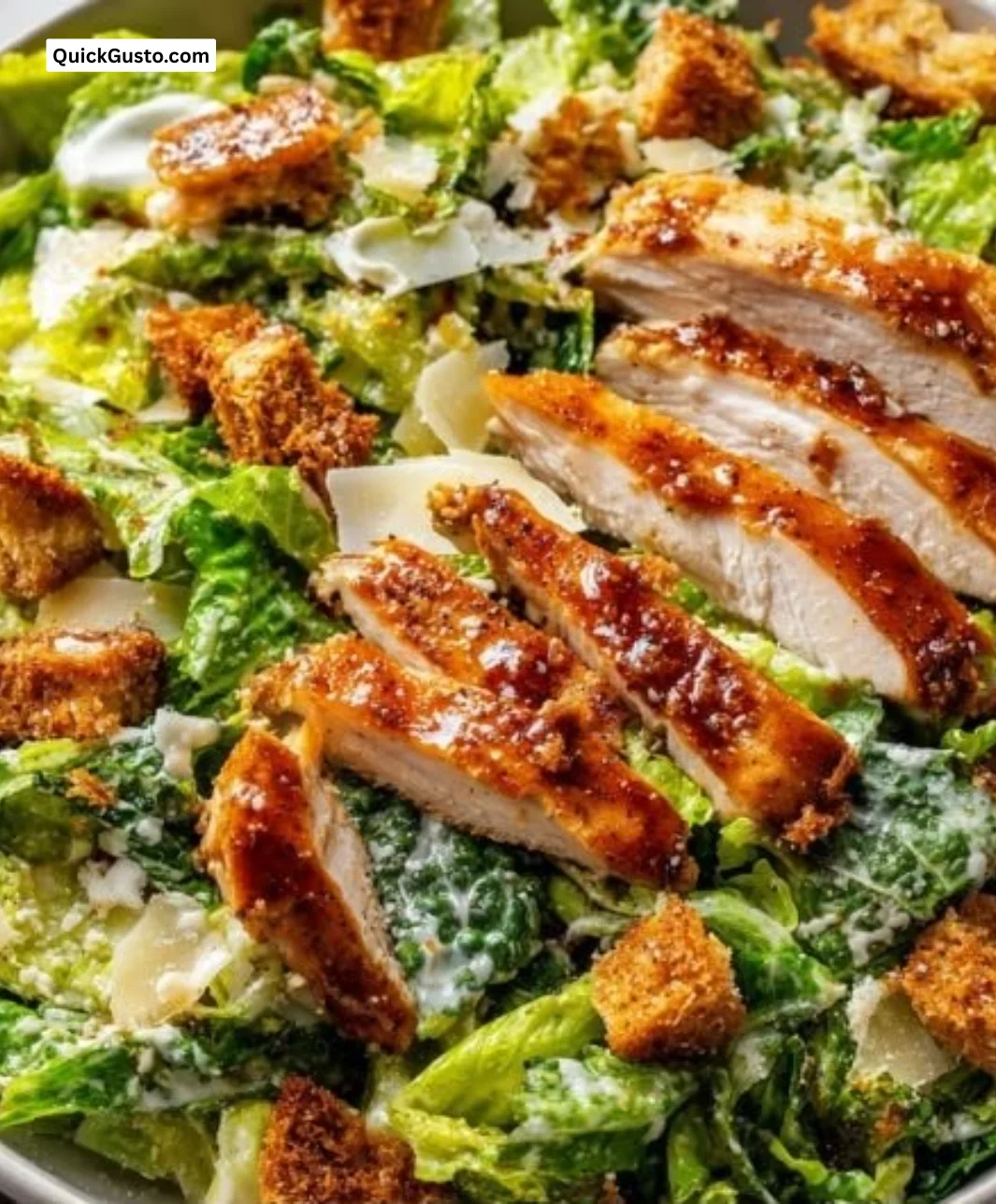 Crispy hot honey chicken Caesar salad with fresh greens and a spicy honey drizzle
