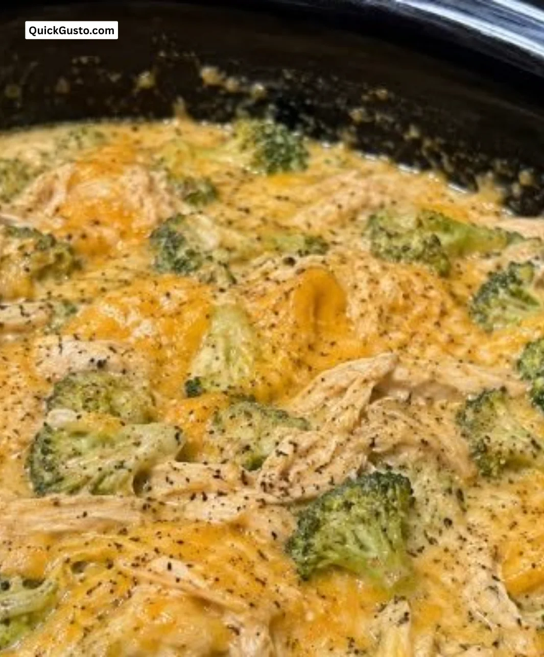 Crockpot creamy broccoli cheddar chicken served in a bowl with fresh broccoli