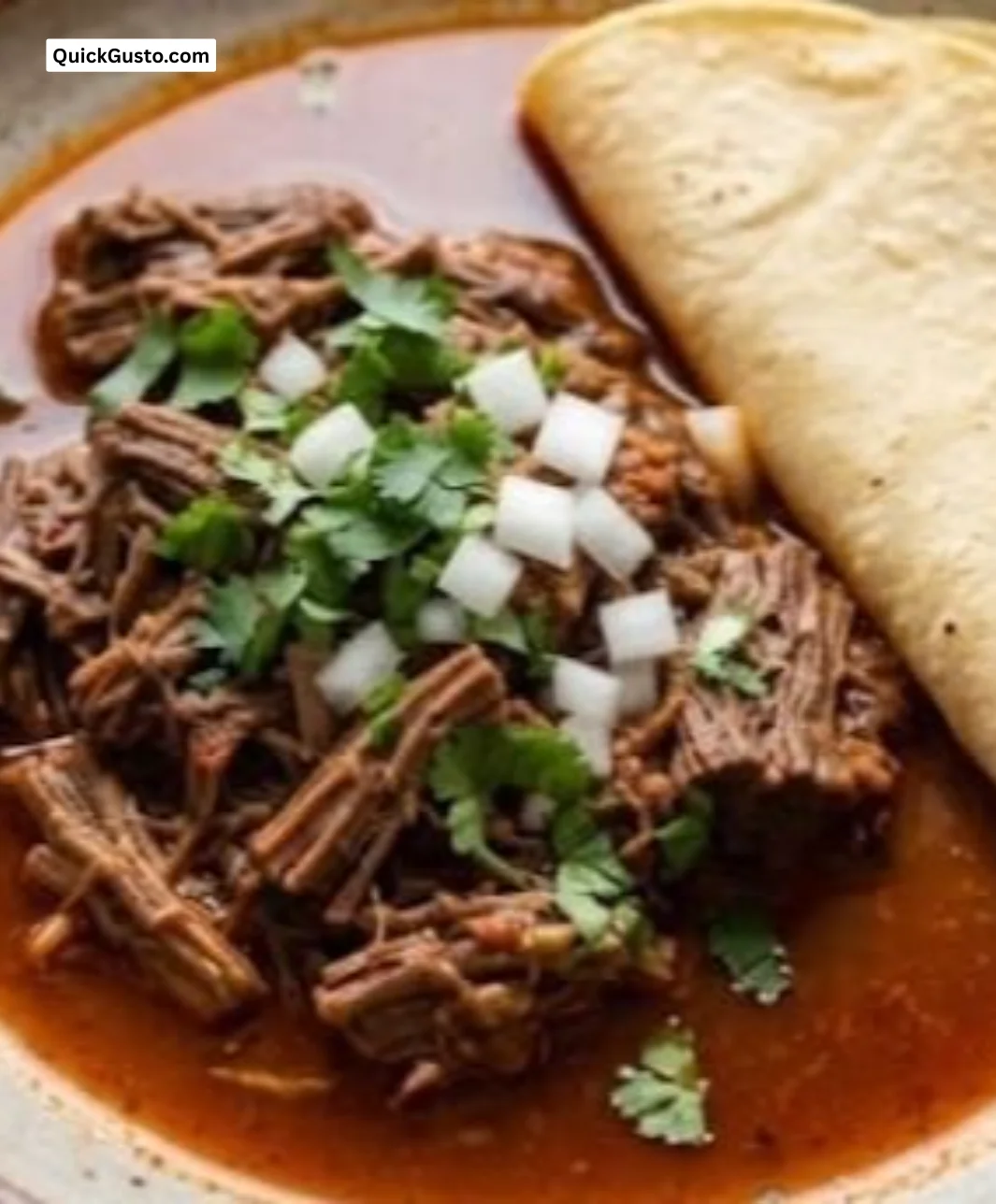 Crockpot shredded beef served in a bowl with toppings
