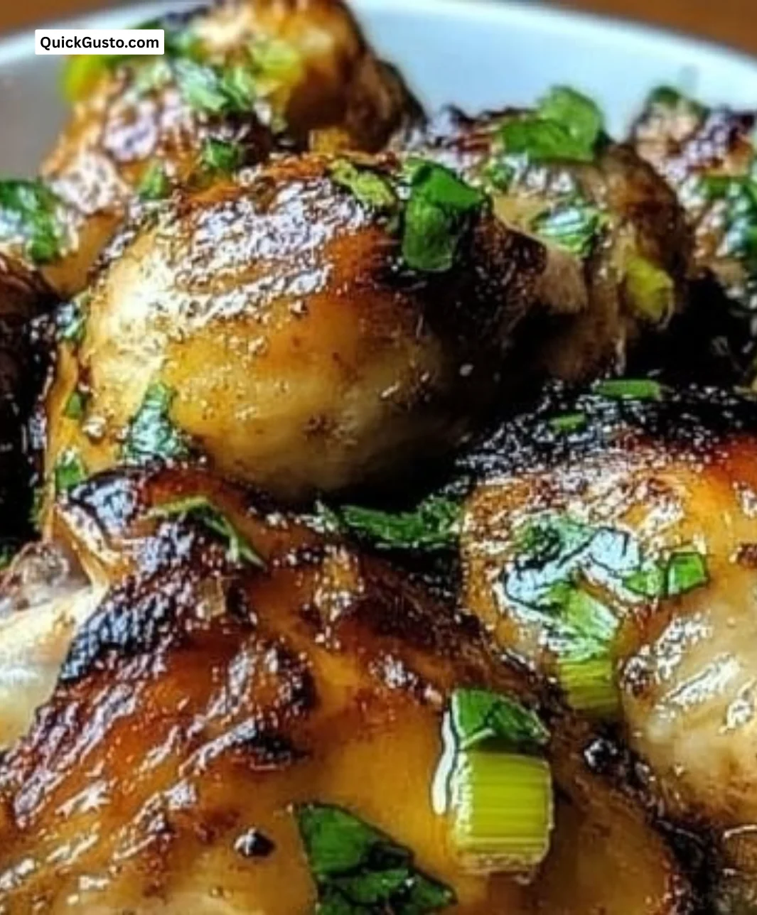 Delicious Cuban Mojo Chicken Thighs garnished with herbs and citrus
