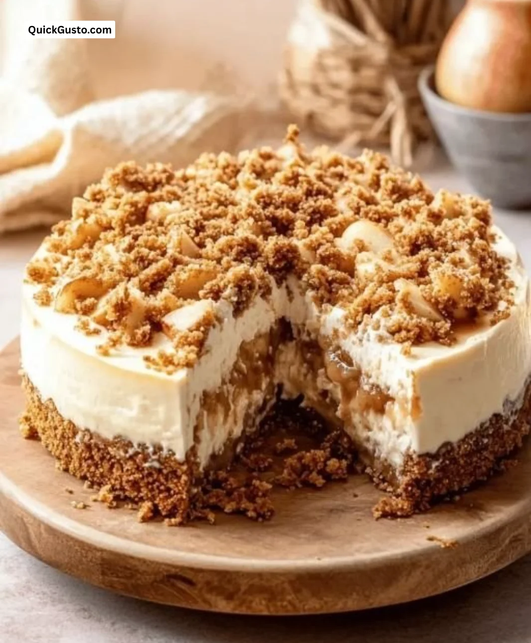 Delicious apple crumble cheesecake topped with crisp crumble and fresh apples