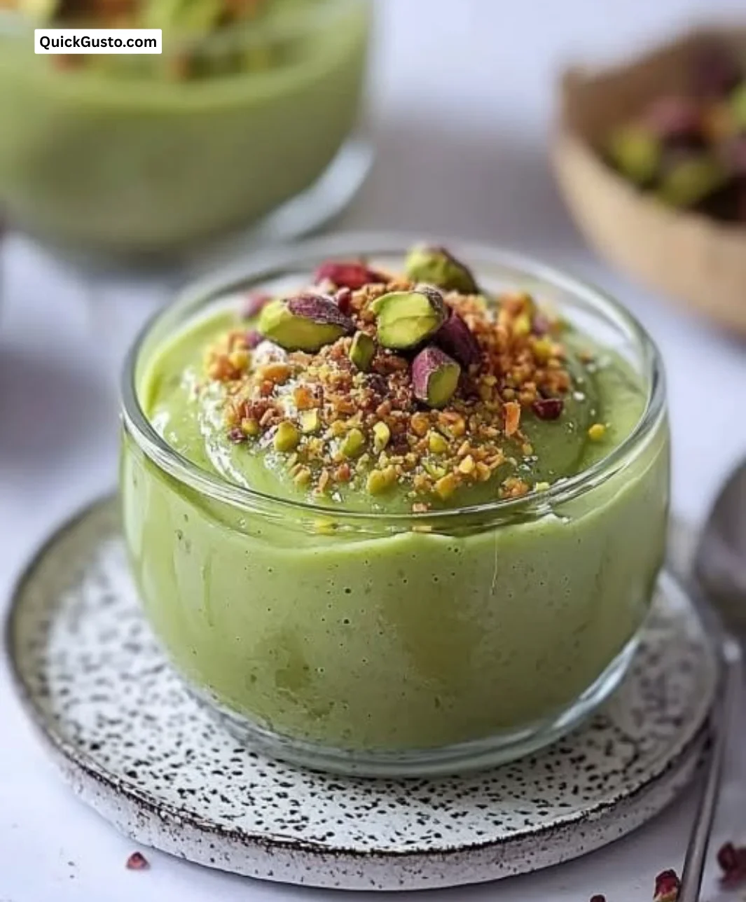 Delicious homemade pistachio pudding served in a bowl with nuts on top.