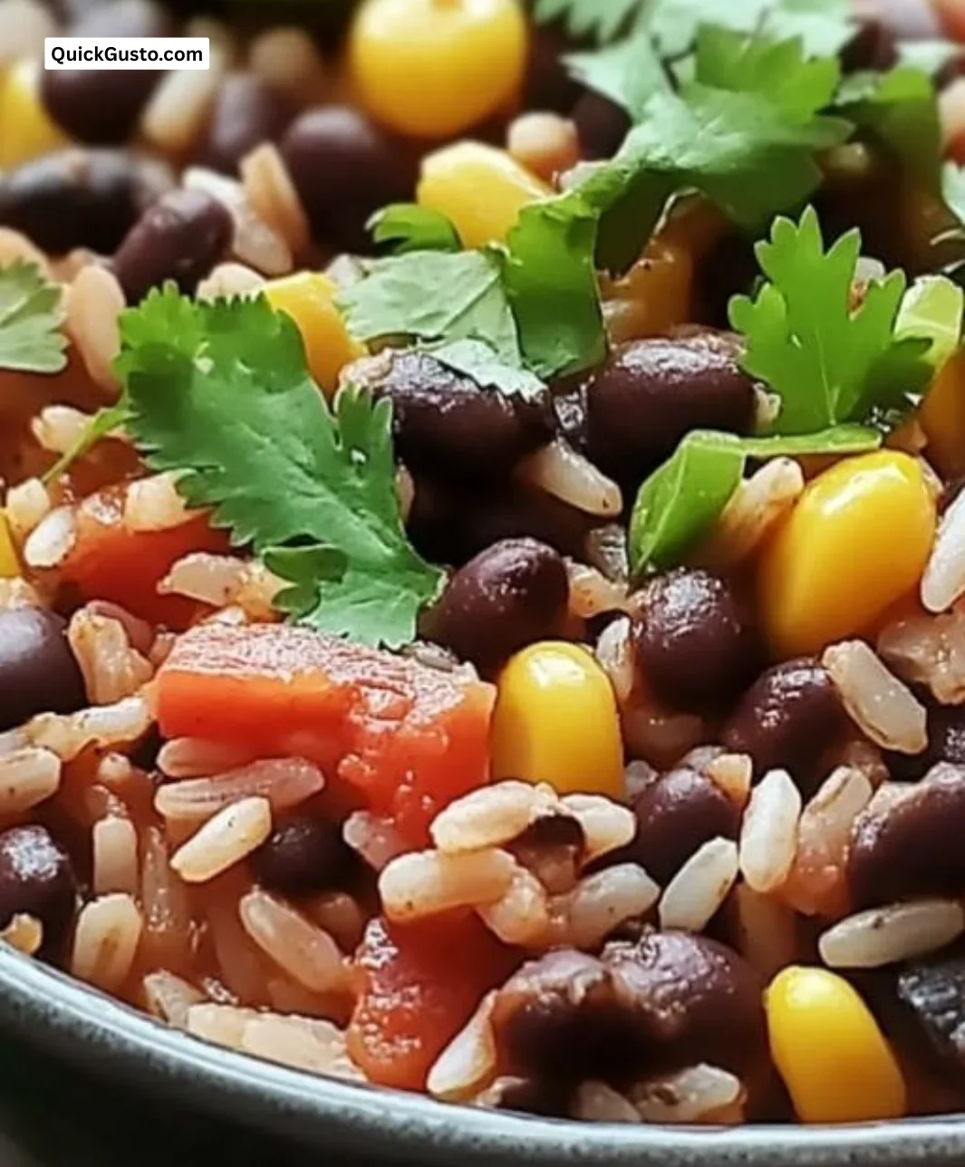 Bowl of easy black beans and rice garnished with herbs and spices.