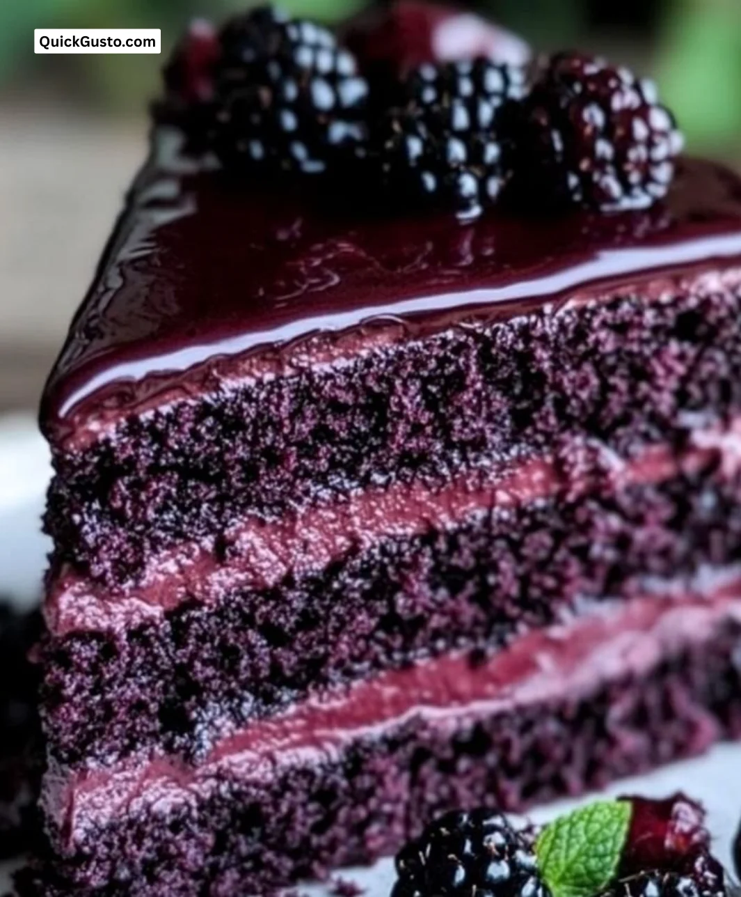 Elegant Blackberry Velvet Cake topped with fresh blackberries and cream frosting