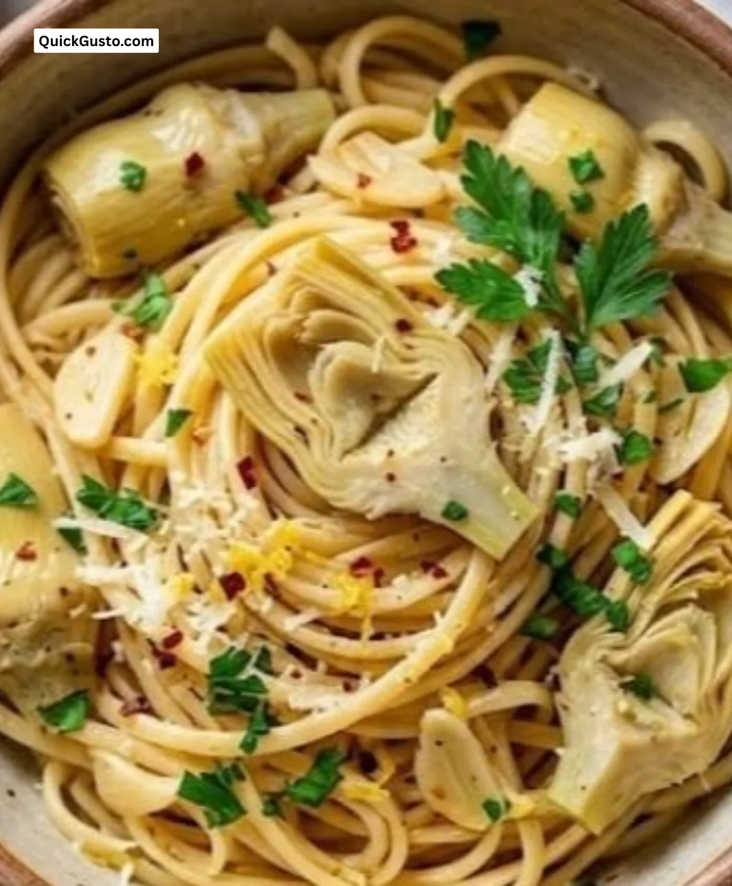 Plate of Garlic Artichoke Pasta garnished with fresh herbs