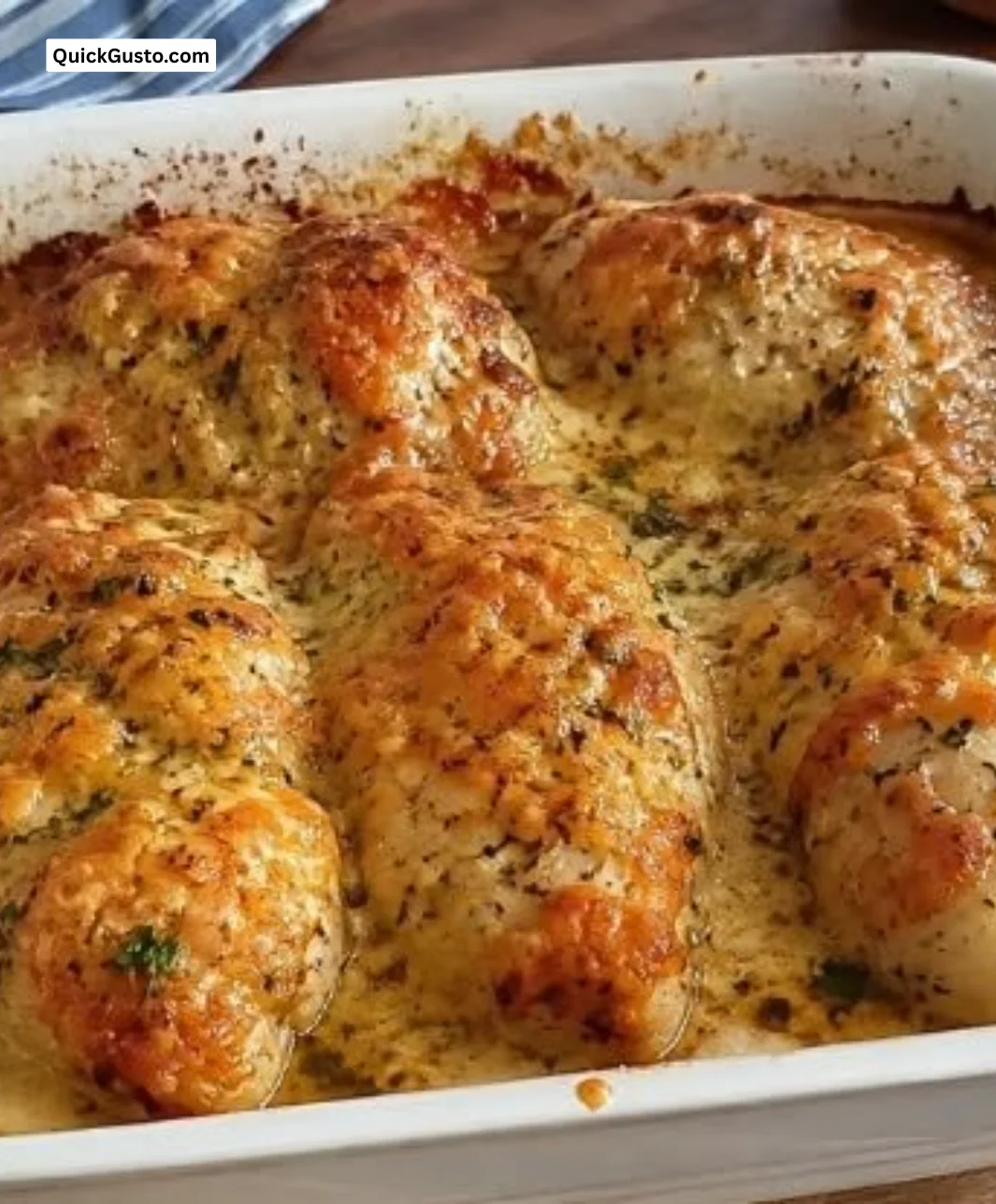 Garlic Parmesan Chicken Bake in a rustic oven dish with herbs and cheese