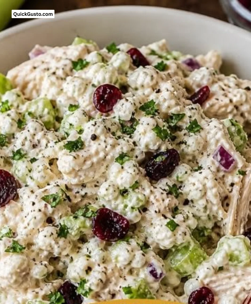 High protein cottage cheese chicken salad served in a bowl with fresh vegetables.