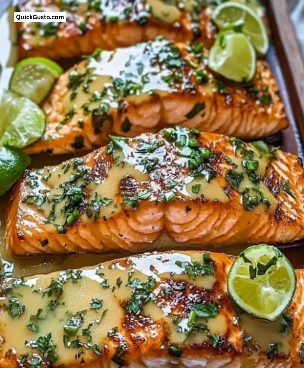 Honey-Lime Garlic Butter Baked Salmon garnished with fresh herbs