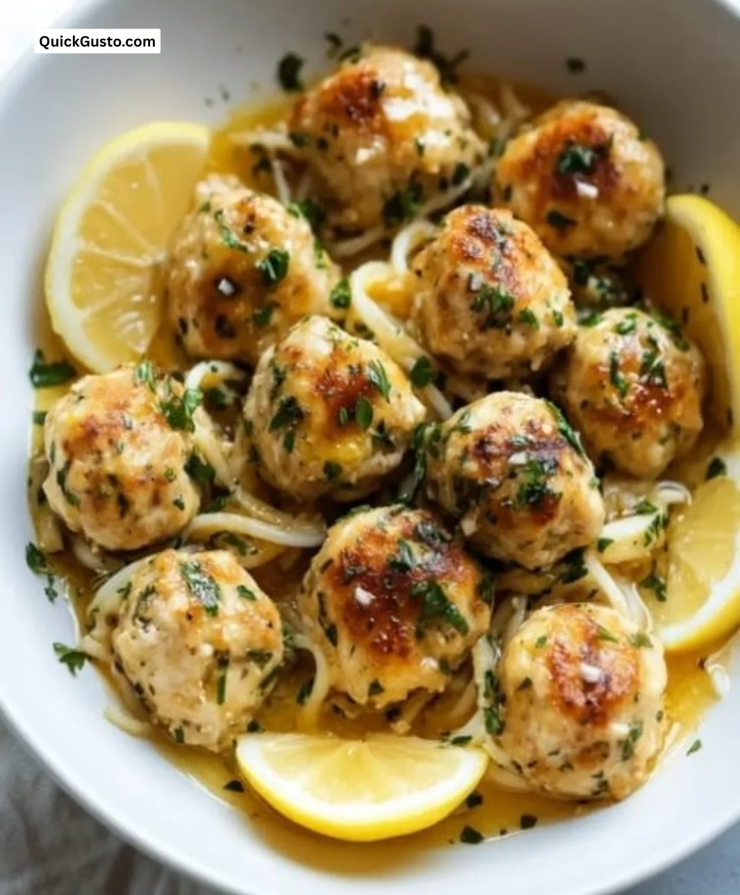 Chicken piccata meatballs in zesty lemon sauce served on a plate