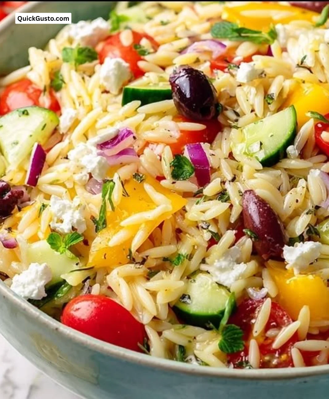 Bowl of Greek Orzo Pasta Salad with fresh vegetables and feta cheese