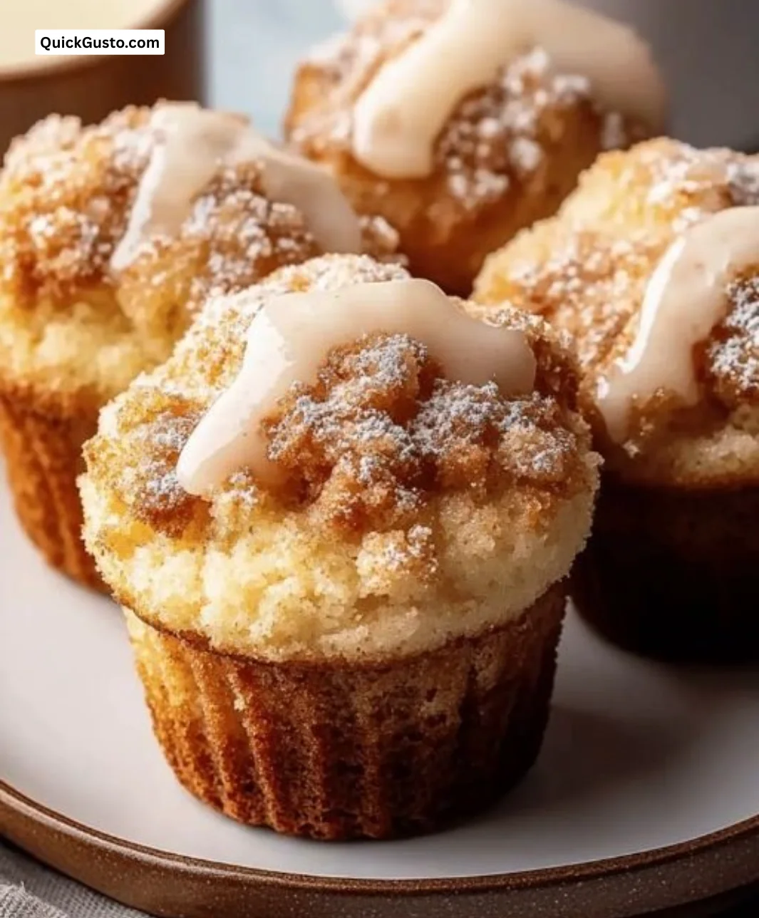 Fluffy coffee cake muffins on a cooling rack, perfect for breakfast.