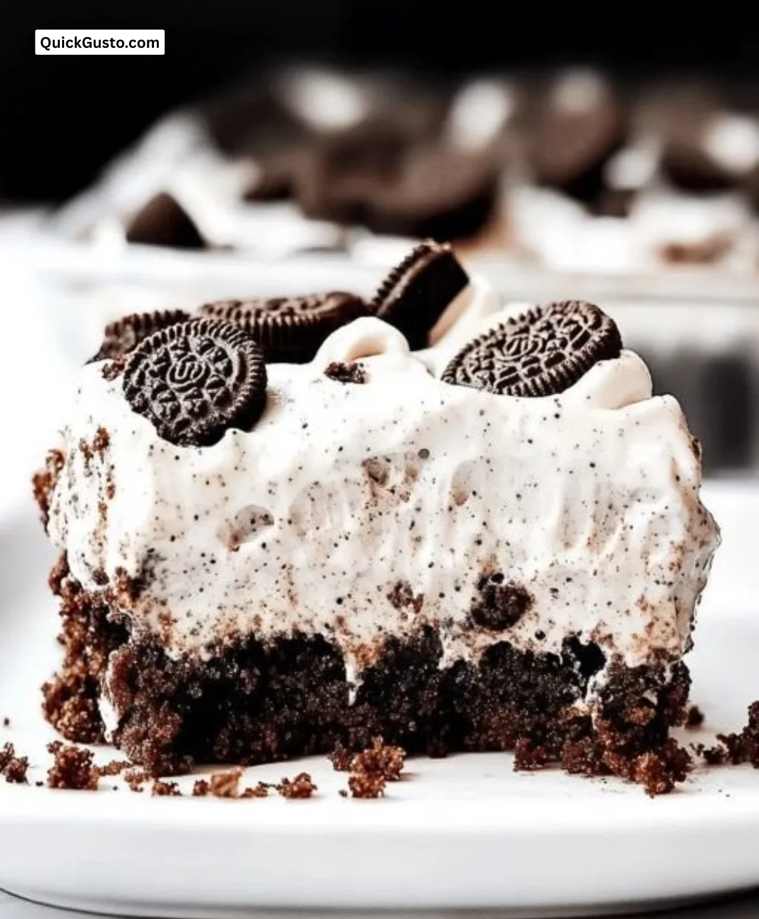 Delicious Oreo Pudding Poke Cake with layers of creamy filling and Oreo crumbles