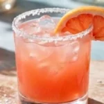 Refreshing Paloma Cocktail served in a glass with grapefruit and lime garnish