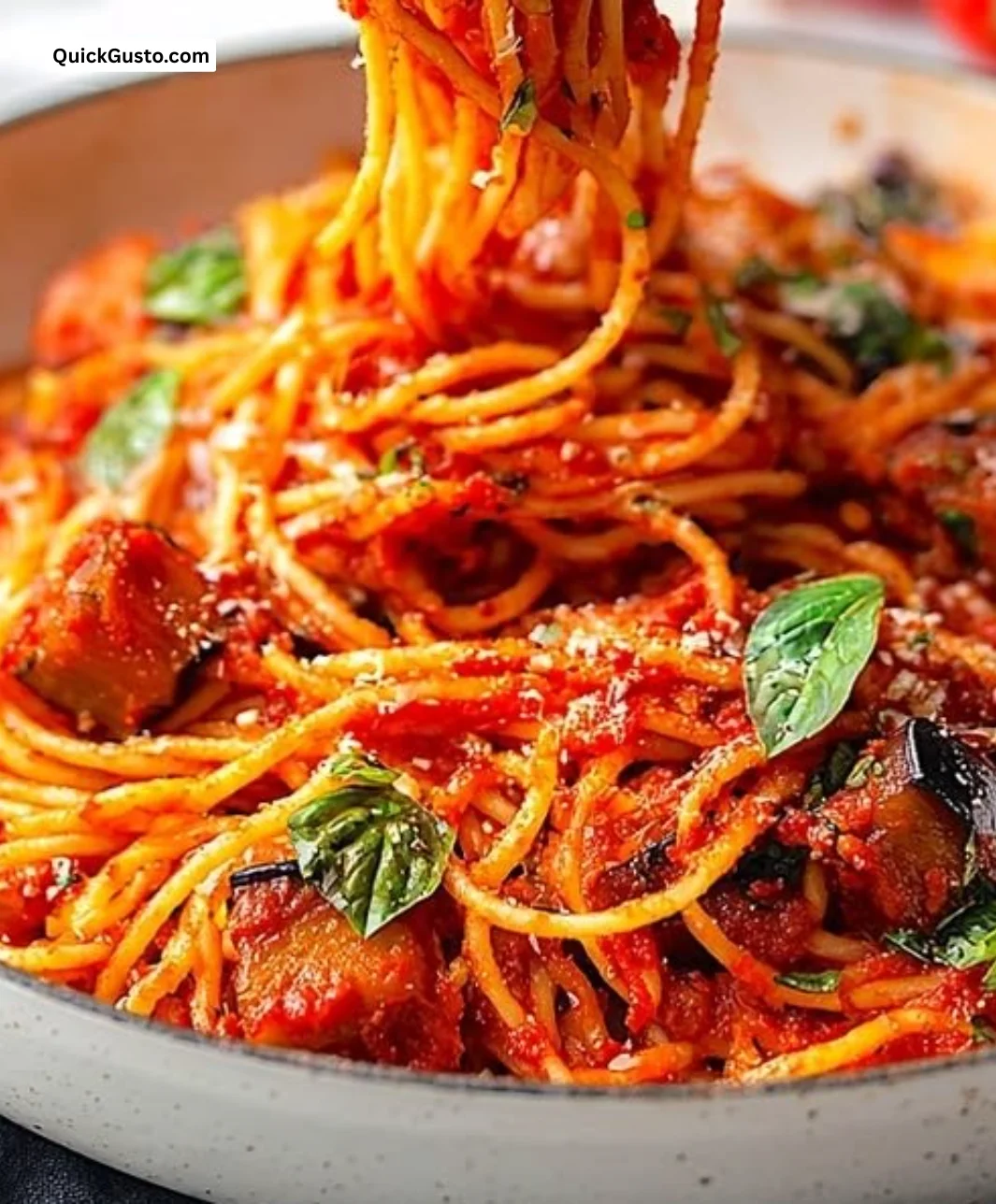 A delicious plate of Pasta alla Norma with eggplant and tomato sauce.
