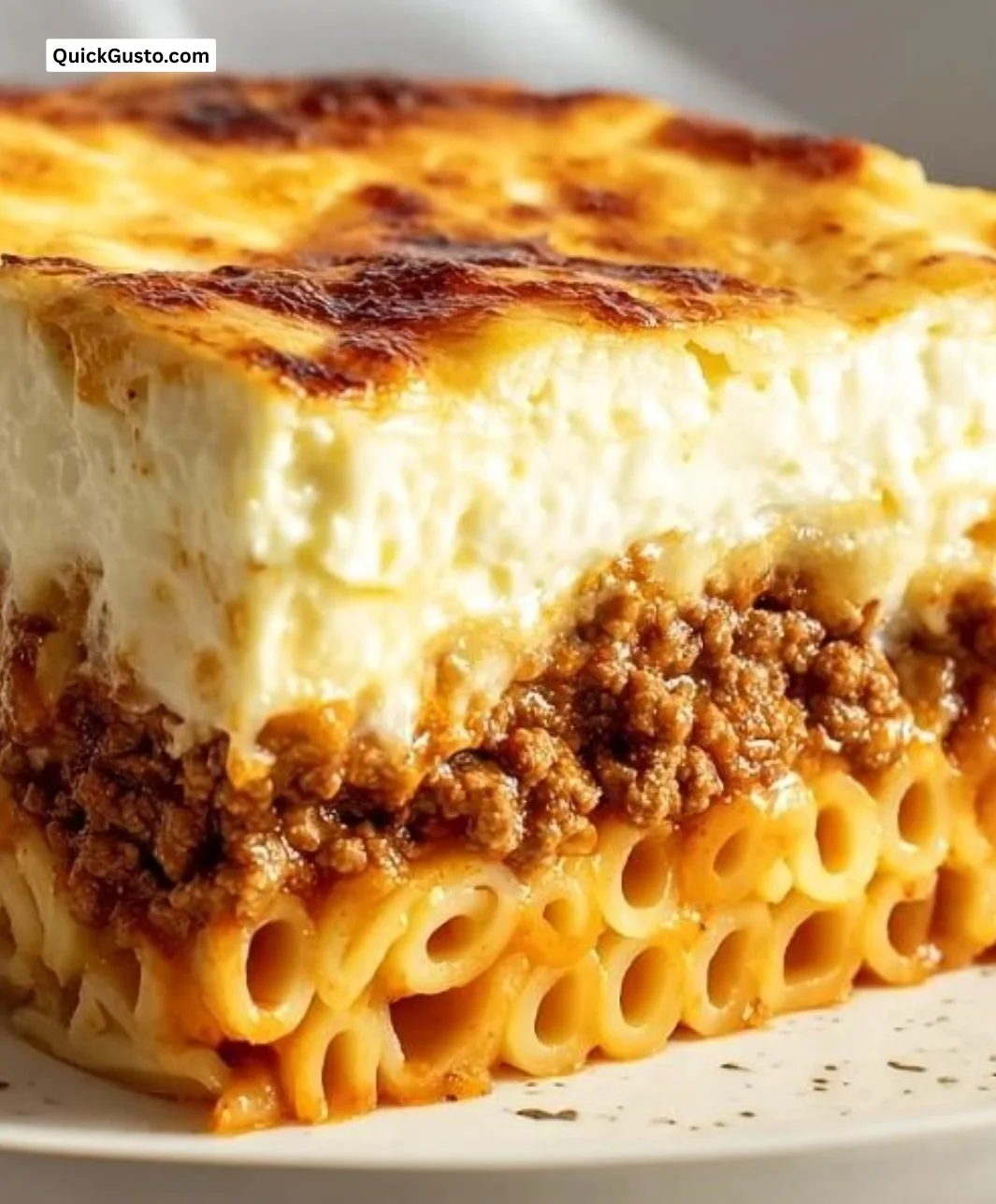 Authentic Greek pastitsio dish served on a family table.