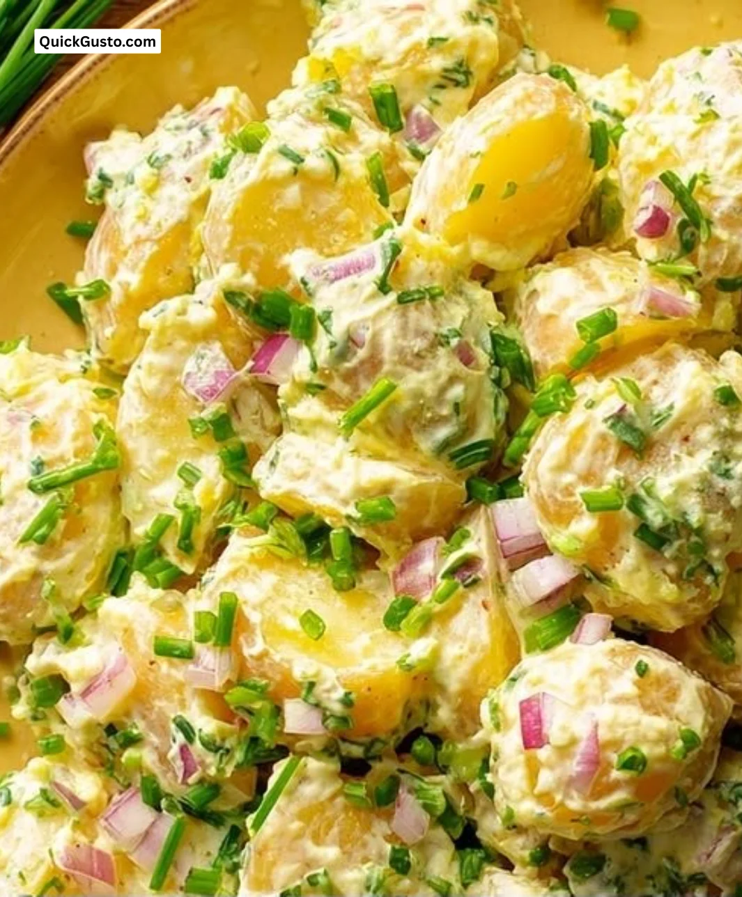 Delicious bowl of perfect mustard potato salad with creamy dressing and herbs.