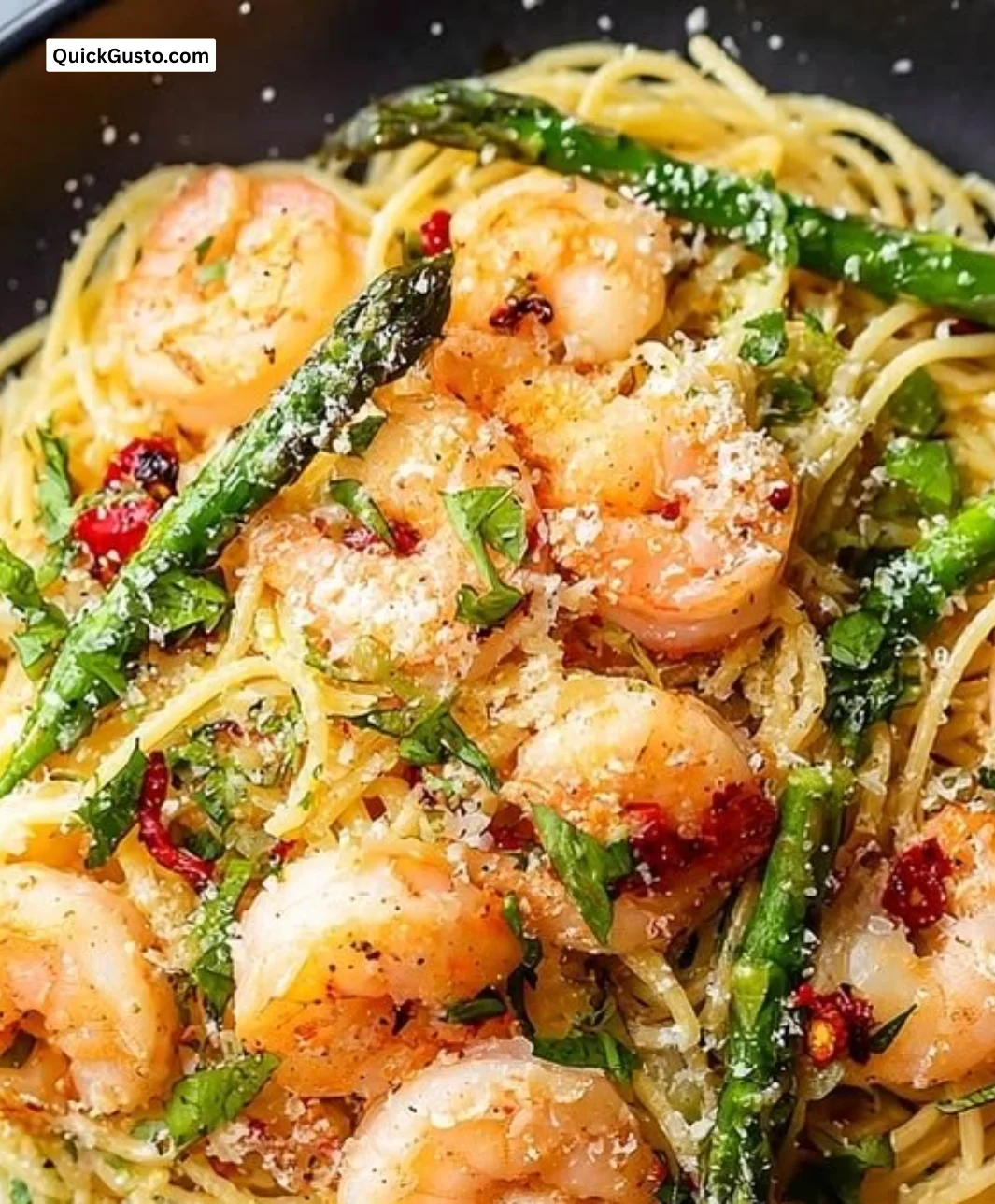Quick angel hair pasta with shrimp and asparagus served on a plate