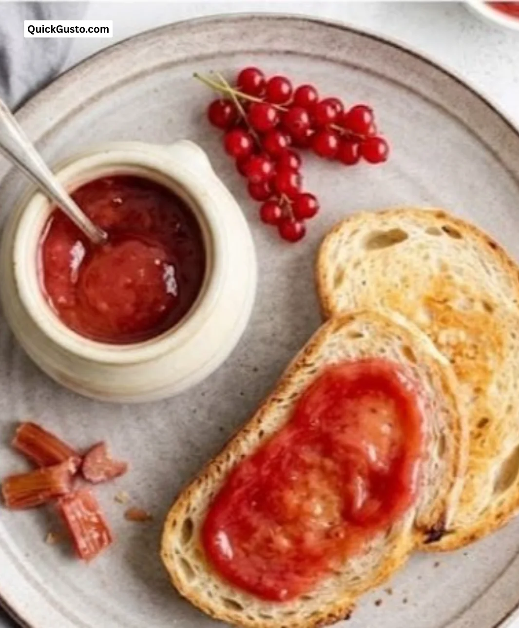 Jar of homemade rhubarb butter spread on toast.
