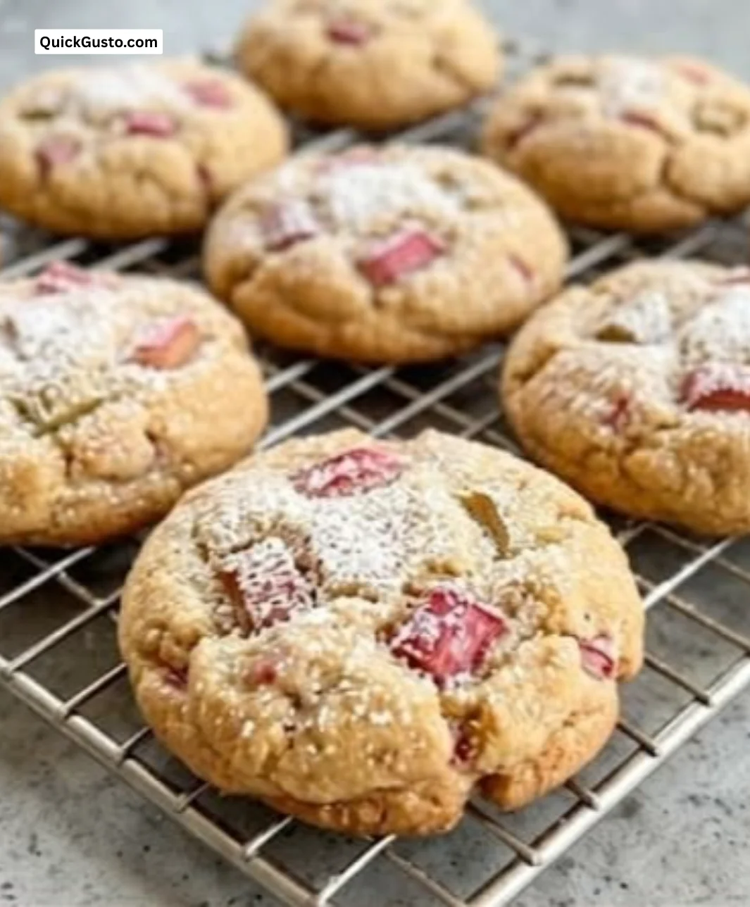 Freshly baked rhubarb cookies on a cooling rack with a rustic background.