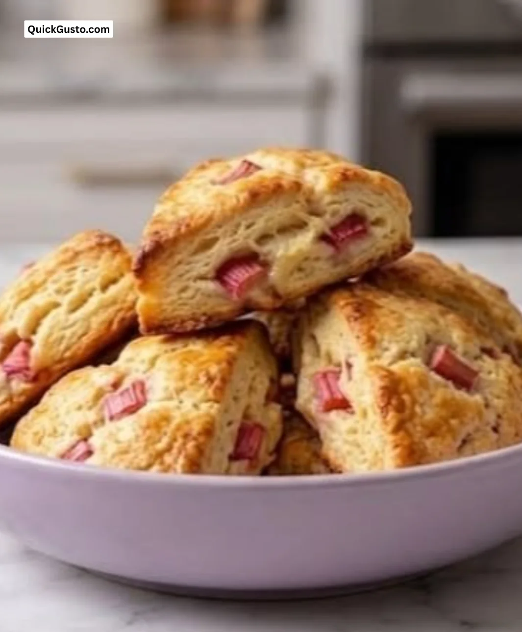 Freshly baked rhubarb scones on a serving plate with strawberries