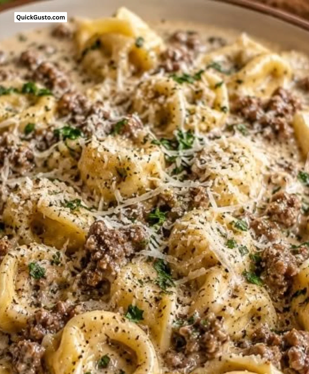 Savory beef tortellini in creamy sauce with Parmesan, a comforting classic dish.