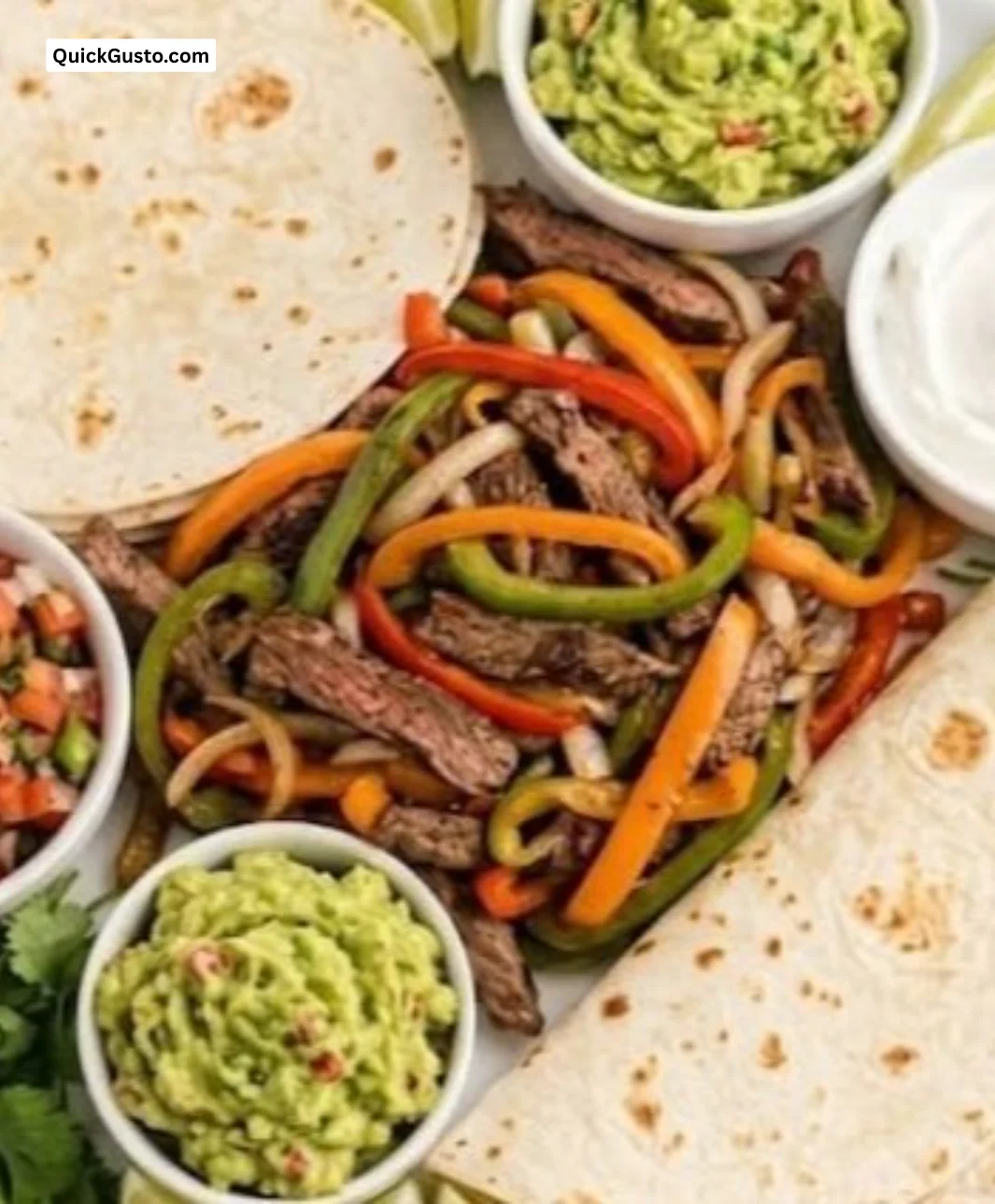 Sizzling Blackstone steak fajitas sizzling on a grill with colorful bell peppers.