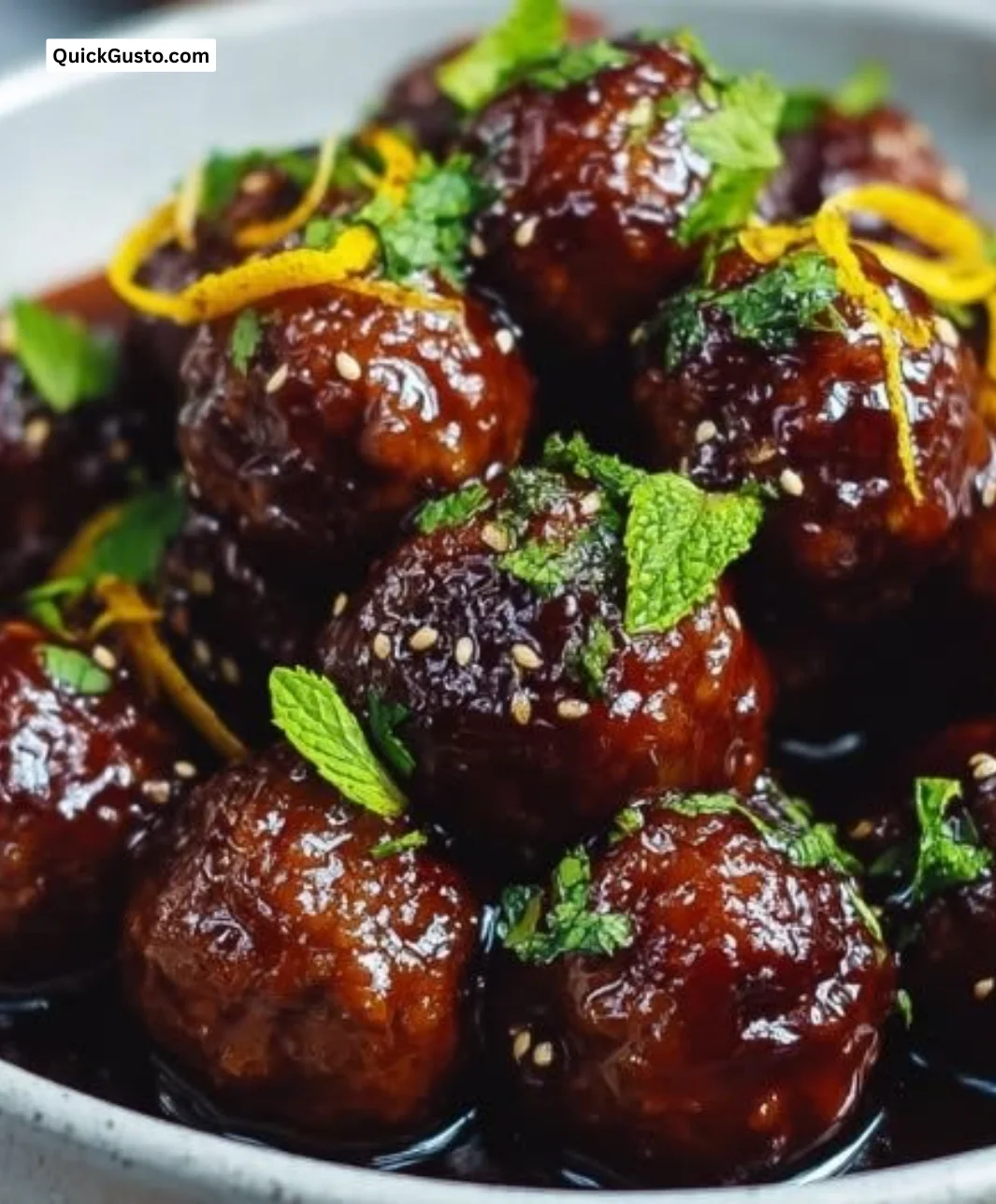 Slow cooker teriyaki meatballs served in a bowl with fresh garnish.