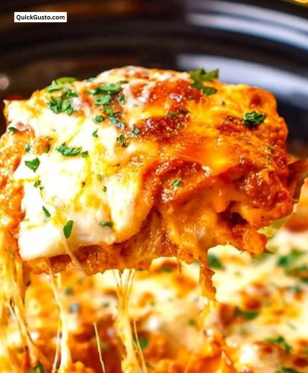 Delicious crockpot lasagna simmering in a slow cooker, topped with cheese and herbs.