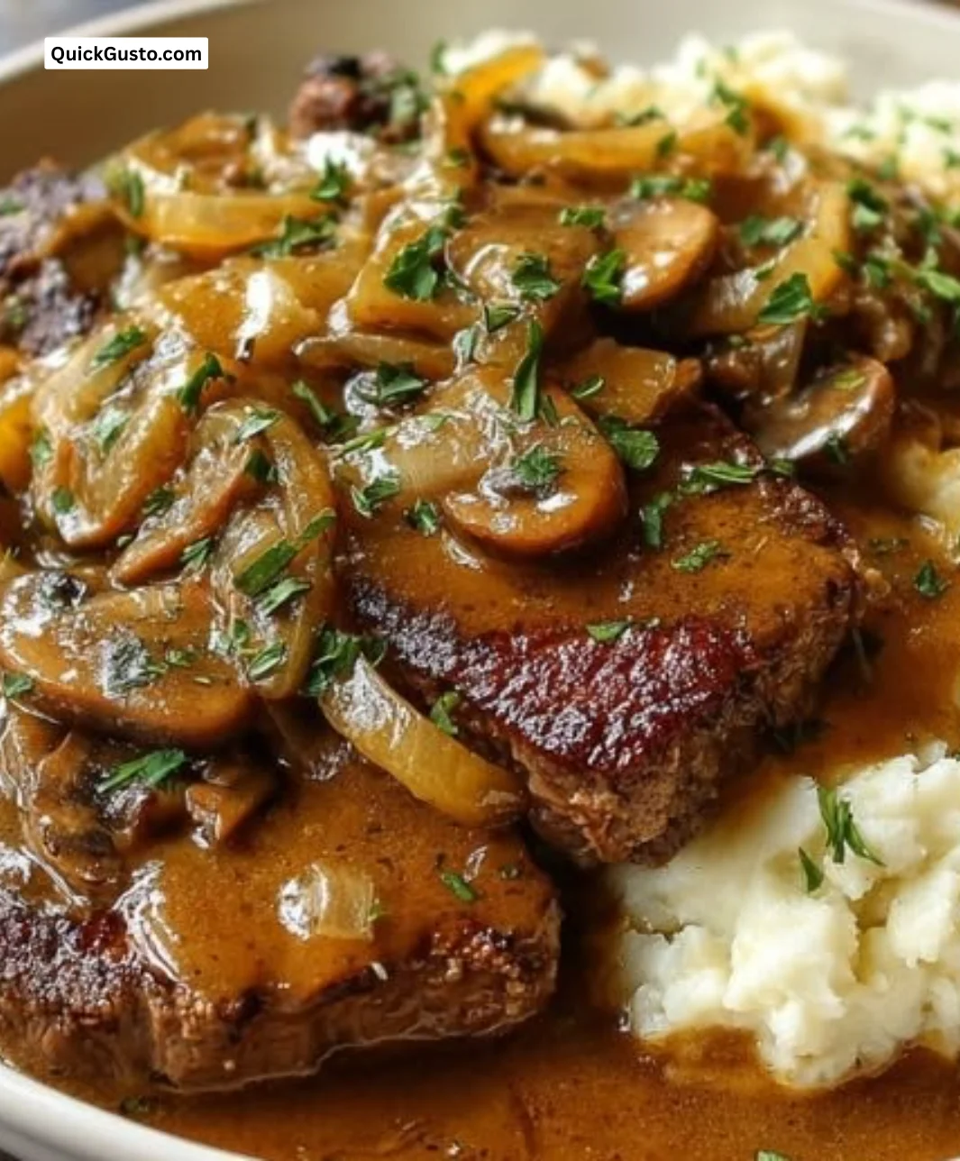 Plate of Smothered Southern Steak served with gravy and sides