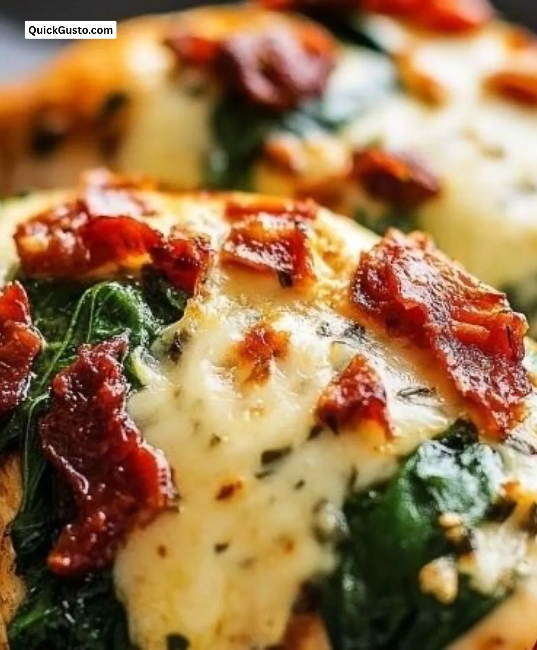 Sun-dried tomato, spinach, and cheese stuffed chicken plated for a delicious meal.