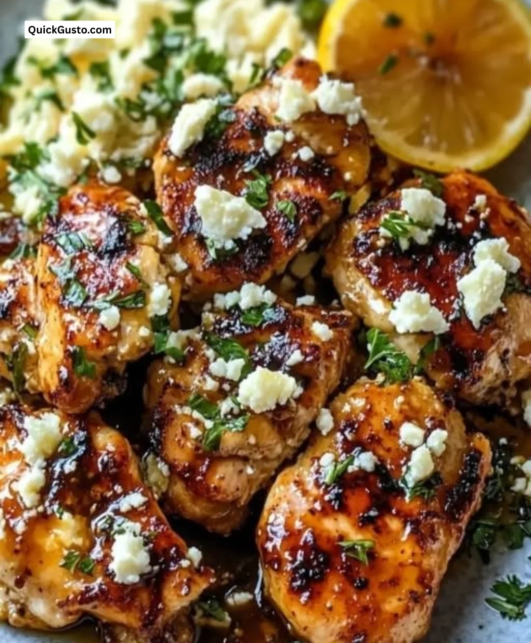 Plate of sweet and spicy hot honey feta chicken garnished with herbs