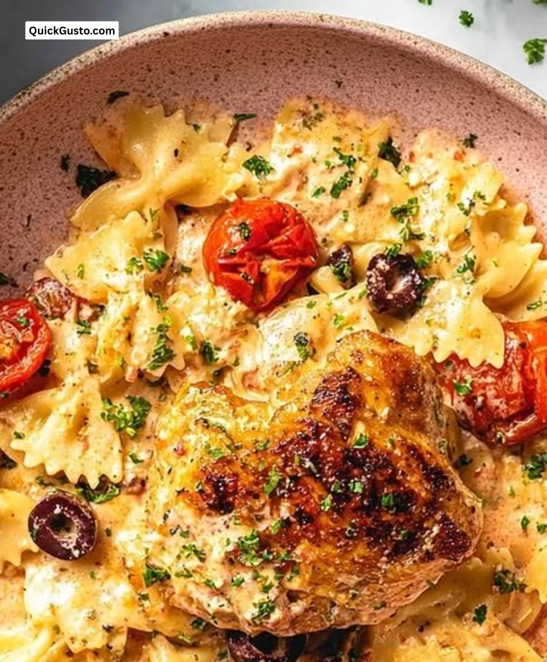 Mediterranean chicken feta pasta served in a bowl with fresh vegetables