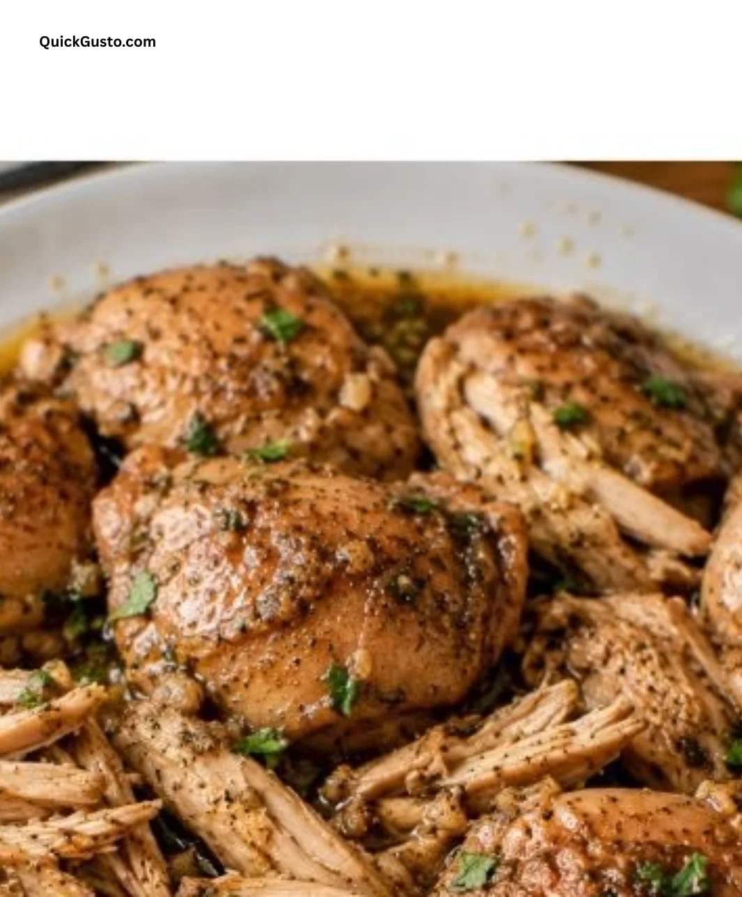 Delicious tender crock pot chicken thighs served on a plate with herbs