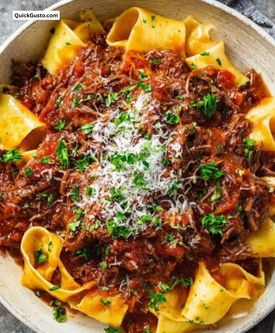 Delicious bowl of ultimate beef ragu served with pasta and herbs