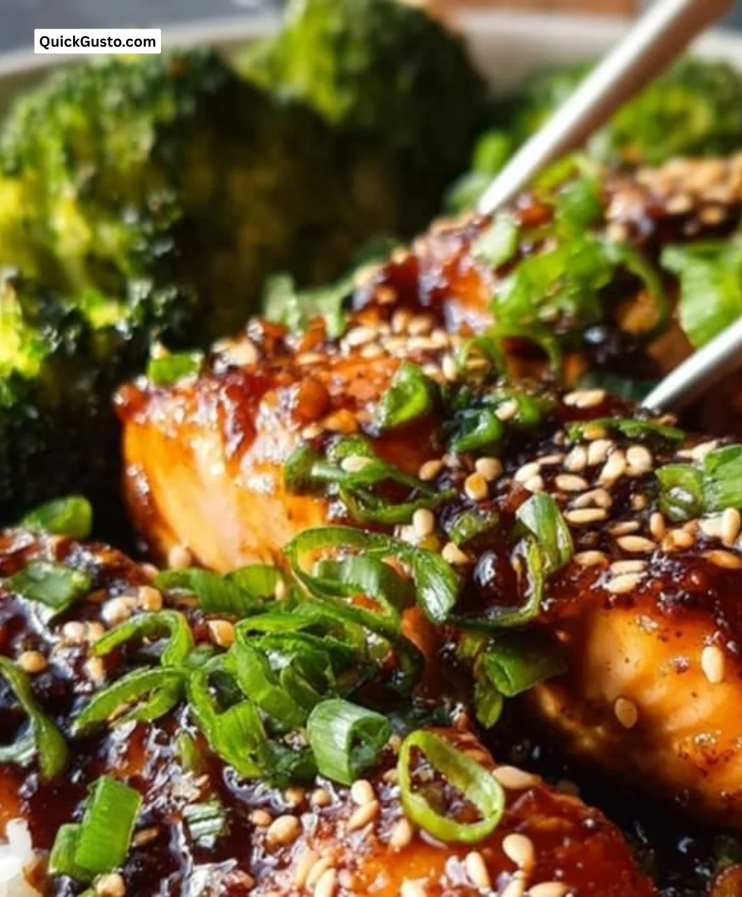 Baked teriyaki salmon garnished with sesame seeds and green onions