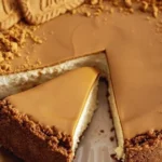 Delicious Biscoff cheesecake garnished with cookies and caramel drizzle.
