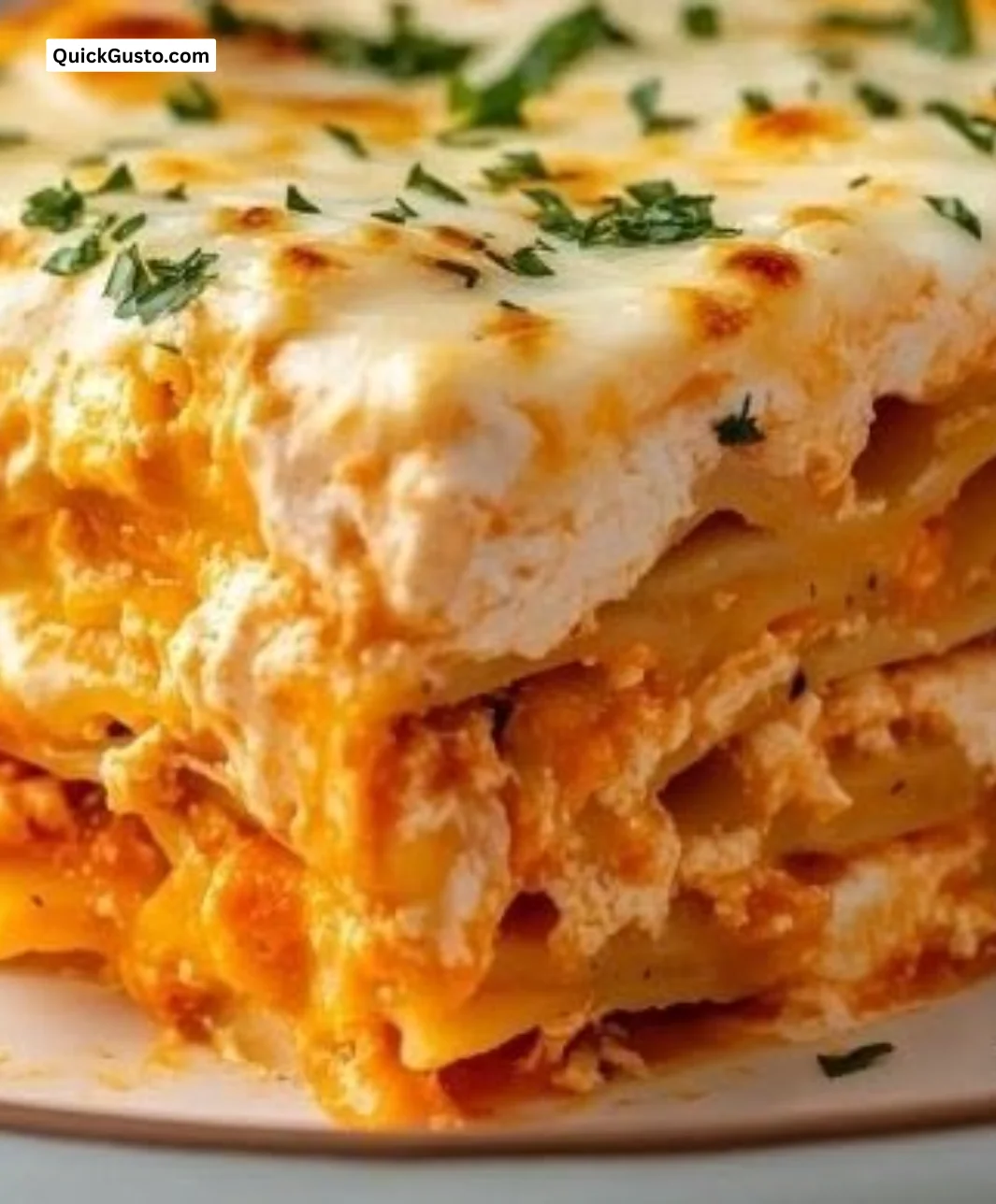Delicious Buffalo Chicken Lasagna topped with cheese and green onions