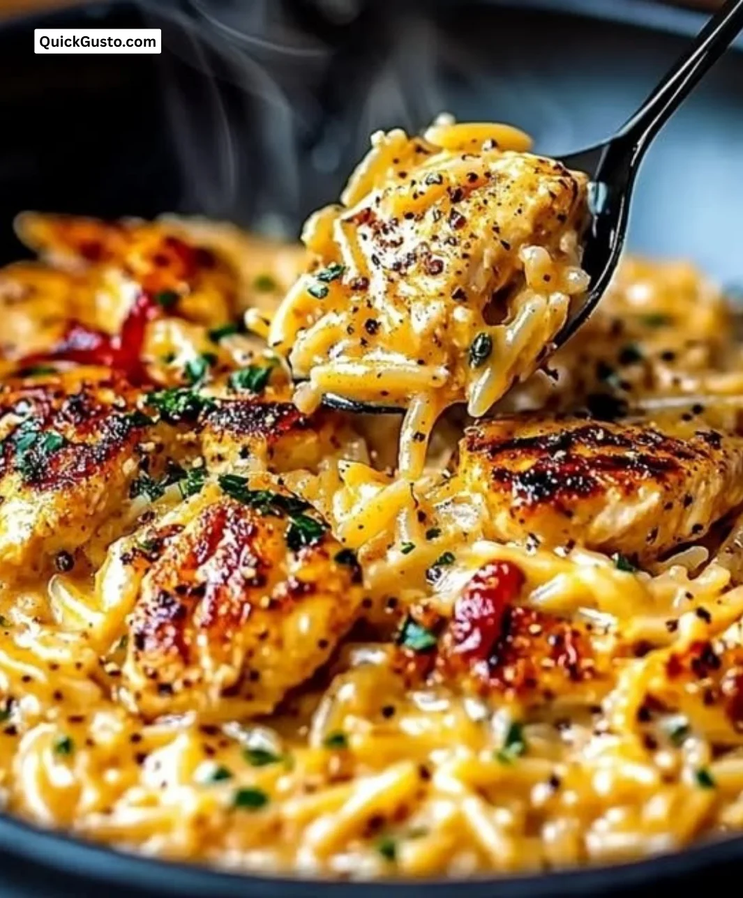Creamy Cajun Chicken Alfredo Orzo served in a bowl with herbs and spices