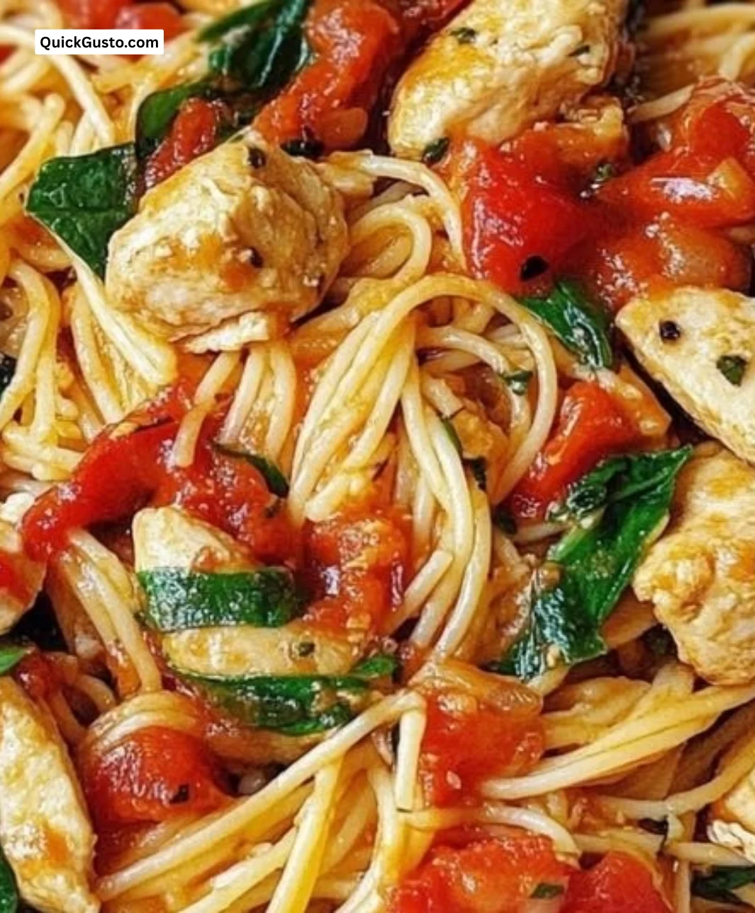 Delicious chicken spaghetti with spinach and tomatoes served in a bowl