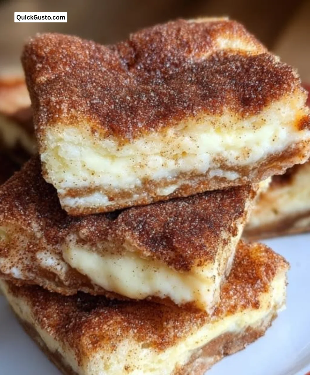 Delicious churro cheesecake bars topped with cinnamon and sugar