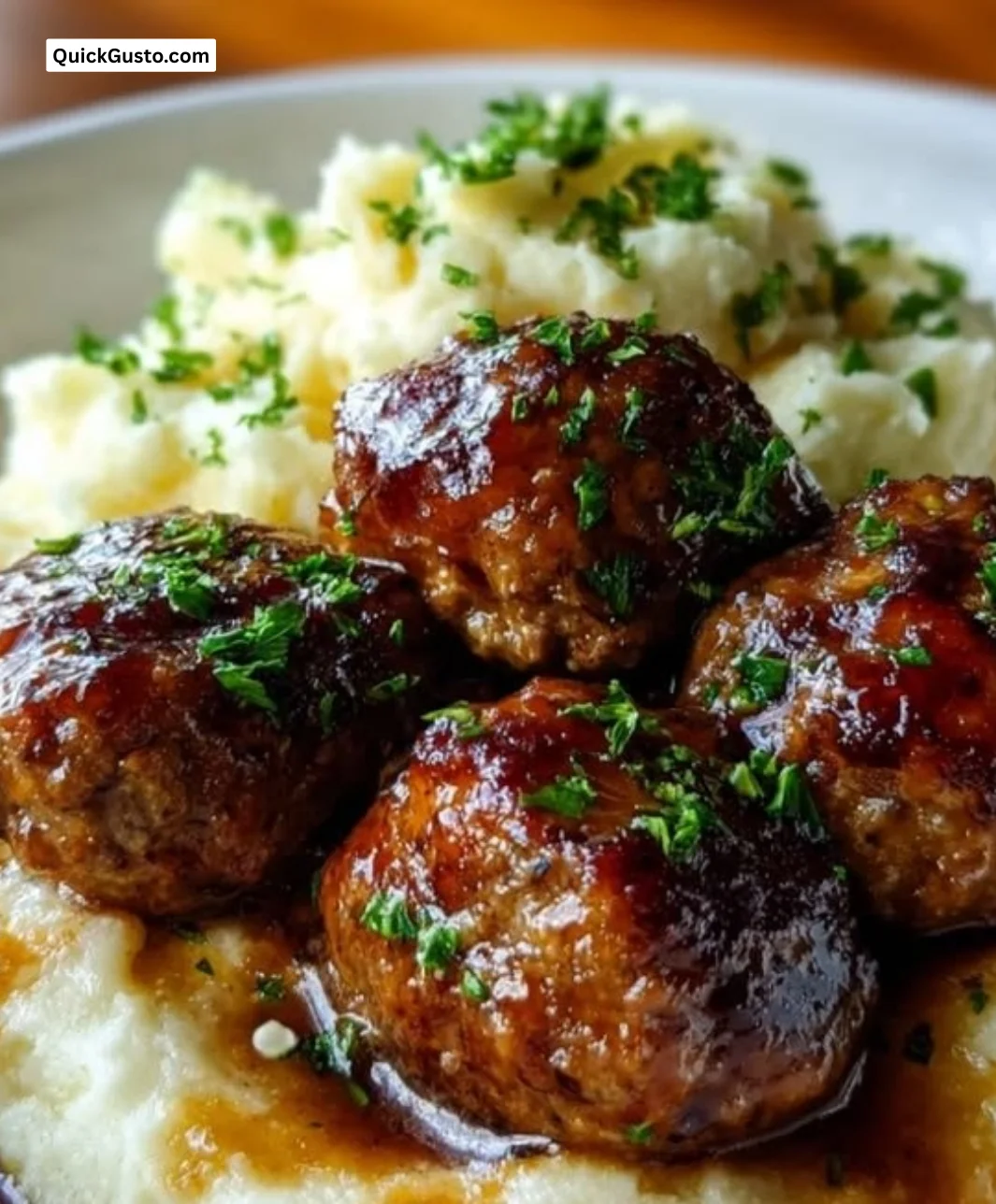 Cozy Salisbury steak meatballs served with garlic herb mashed potatoes in a bowl