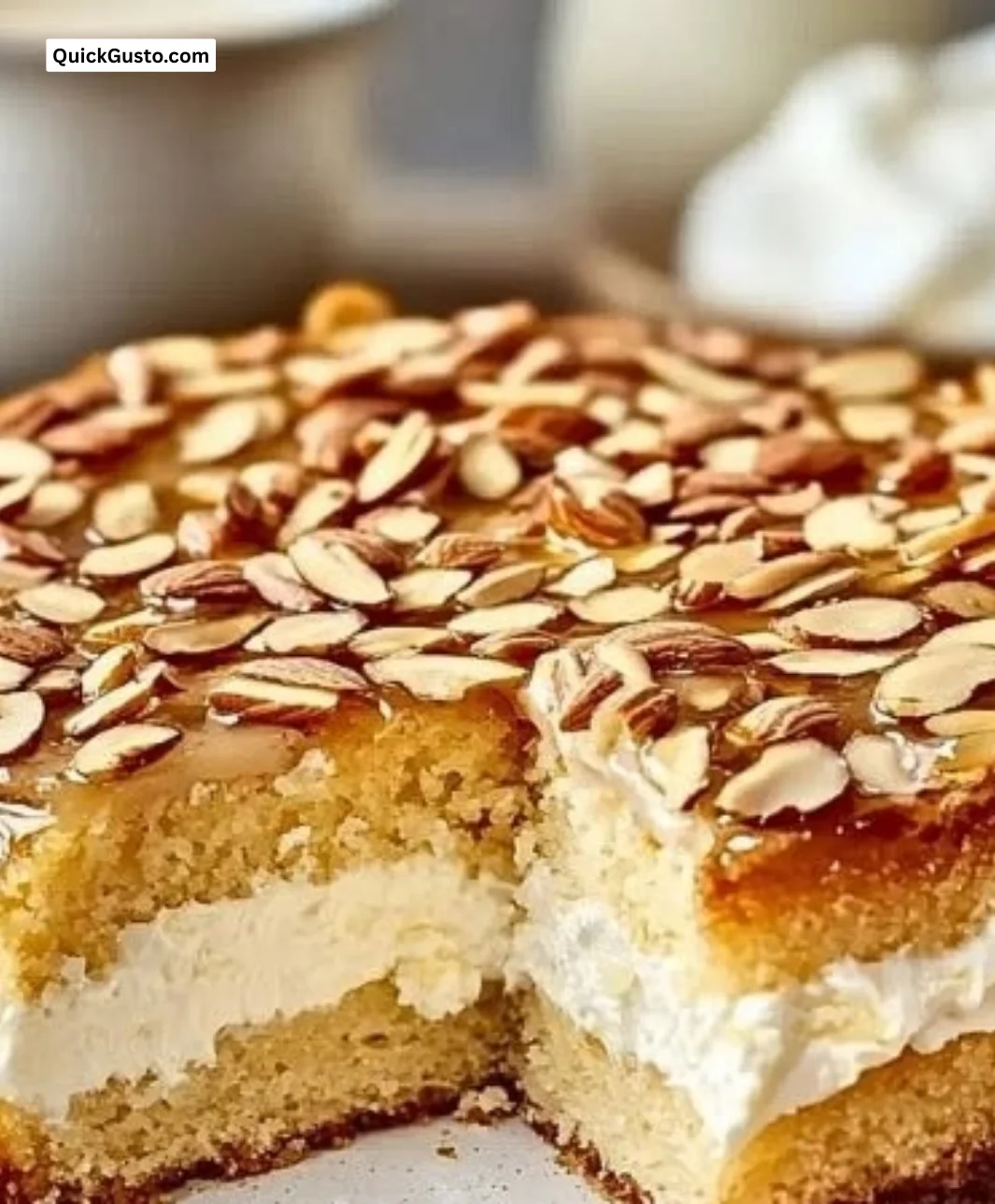 Slice of Creamy German Bee Sting Cake with honey and almond topping