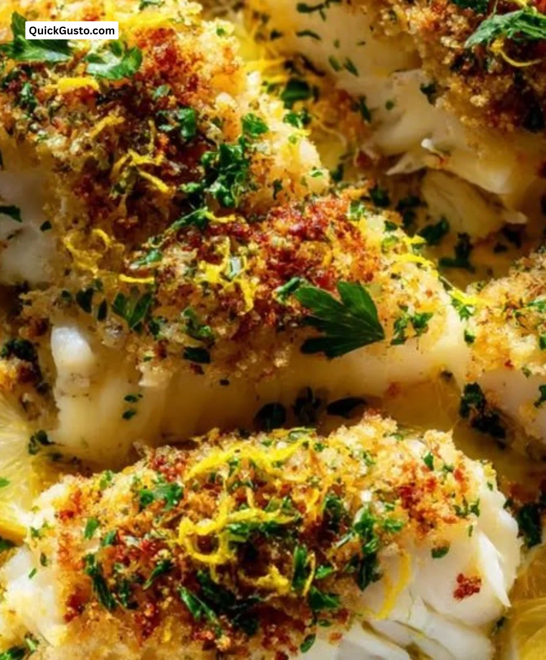 Plate of crispy Boston baked cod served with lemon and herbs