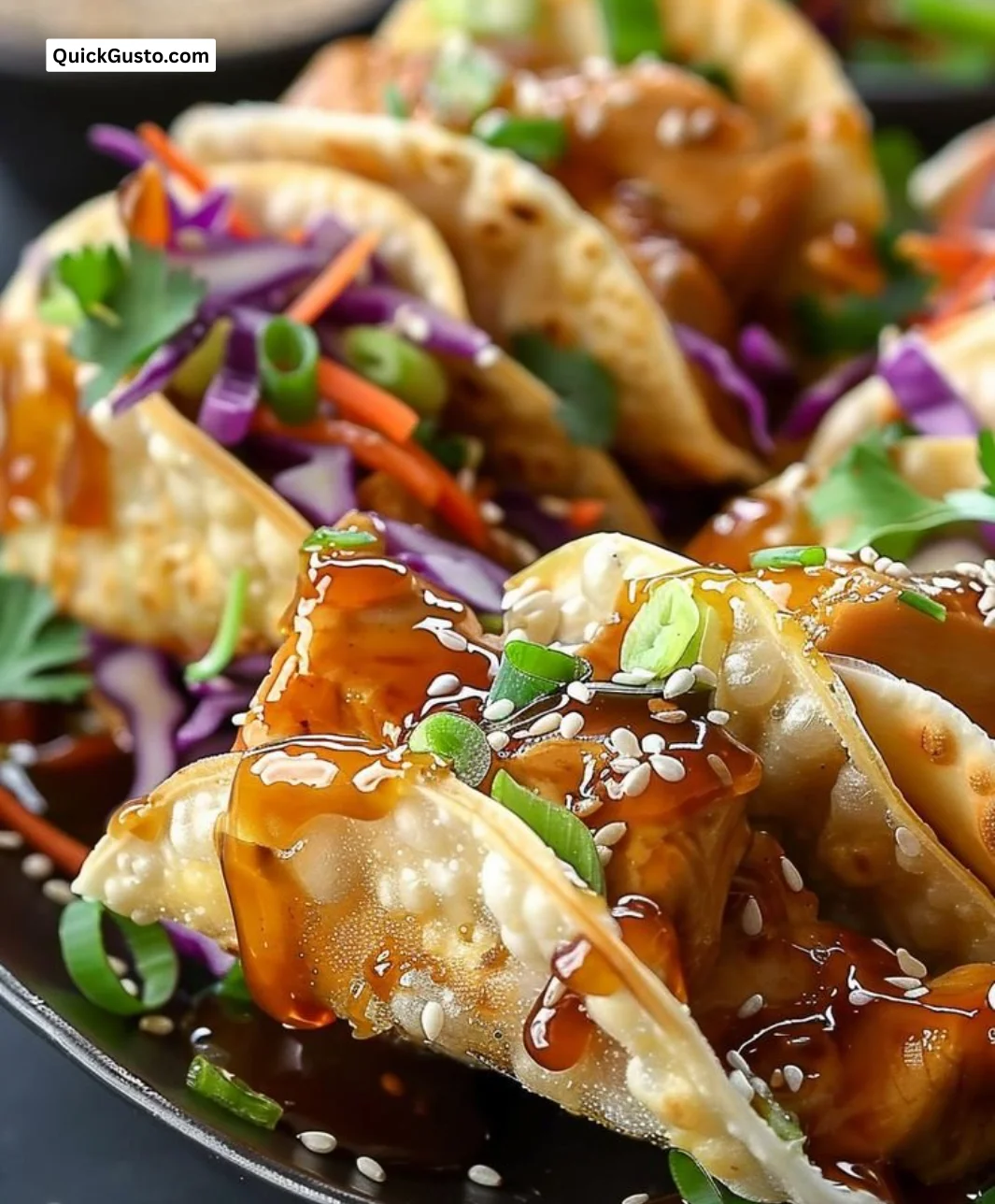 Plate of crispy chicken wonton tacos garnished with fresh cilantro and lime