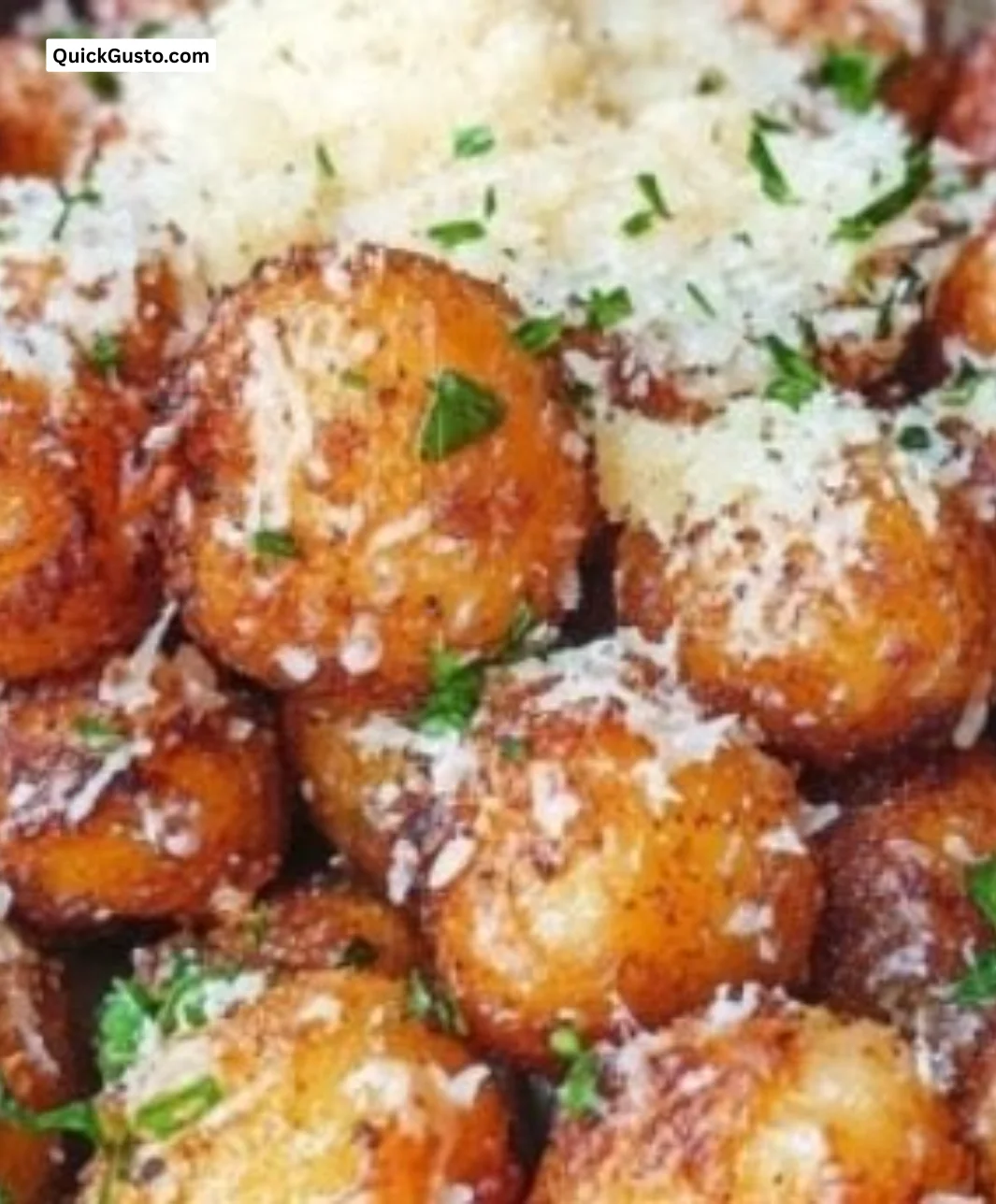Crispy parmesan garlic potato balls served on a plate, perfect for gatherings.
