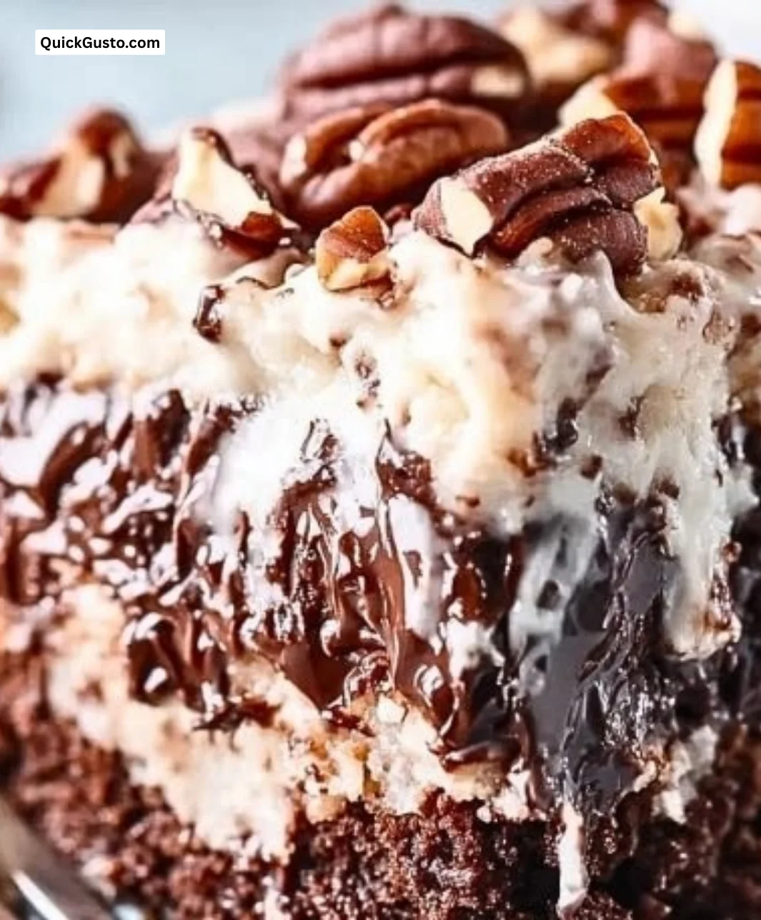 Slice of German Chocolate Poke Cake with coconut pecan frosting
