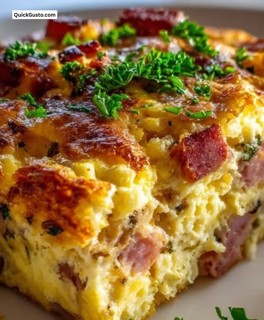 Hearty beef breakfast casserole with ham, cheese, and eggs ready to serve.