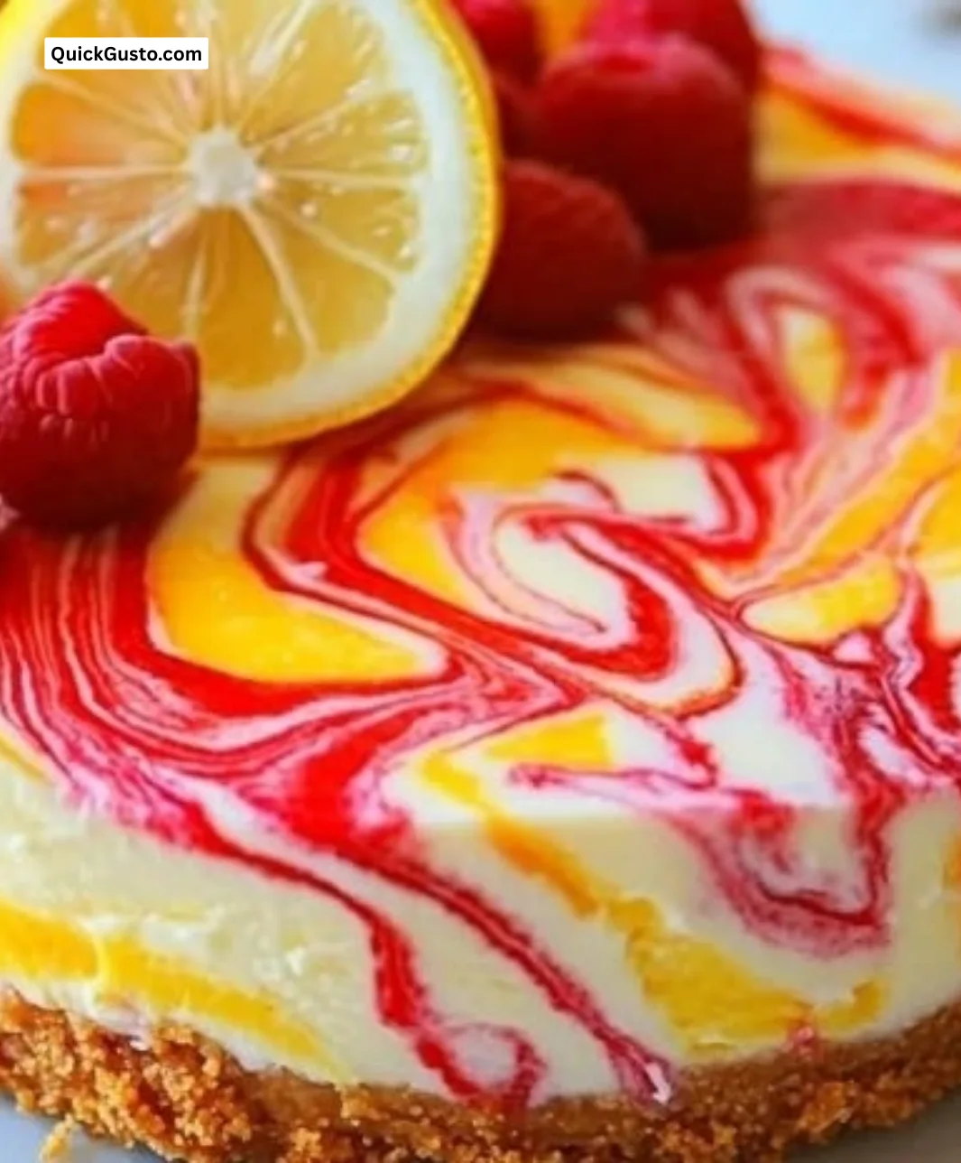 Slice of Lemon Raspberry Swirl Cheesecake with raspberries on top