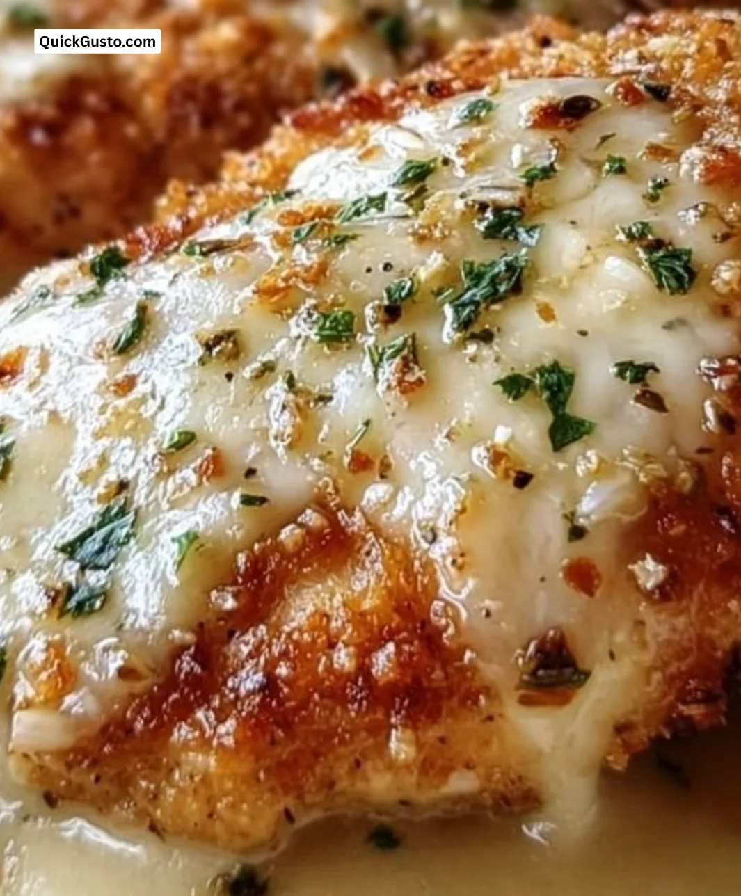 Crispy and cheesy Longhorn Steakhouse Parmesan Chicken, served with sides.